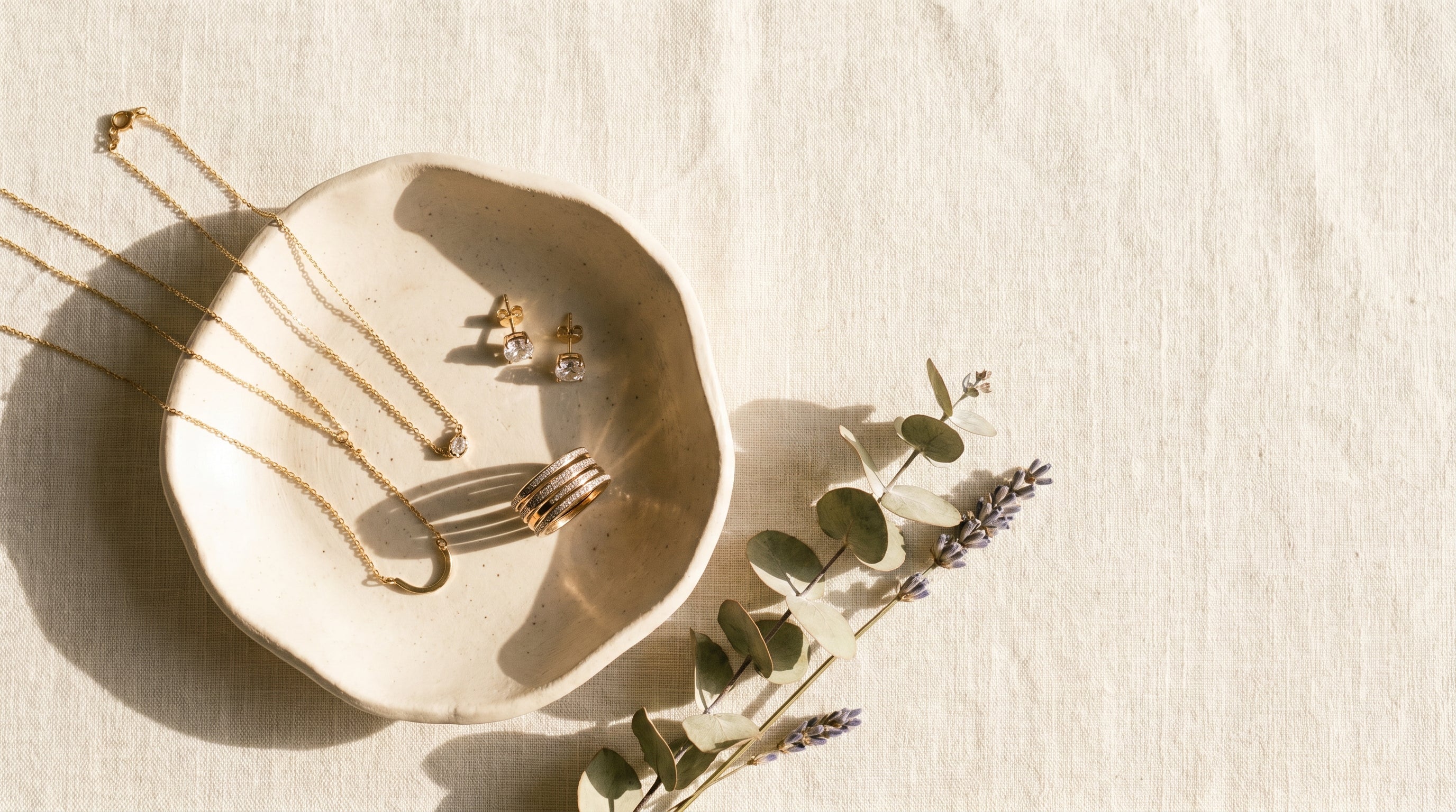 Jexyna jewellery flatlay on cream linen